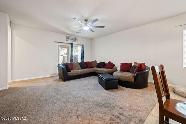 living area featuring carpet floors, ceiling fan, and baseboards