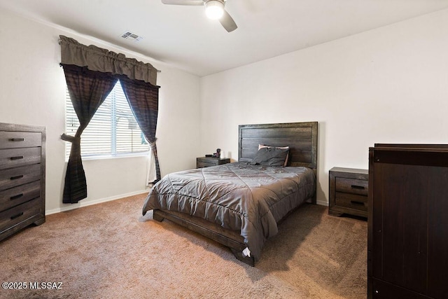 carpeted bedroom with baseboards, visible vents, and ceiling fan