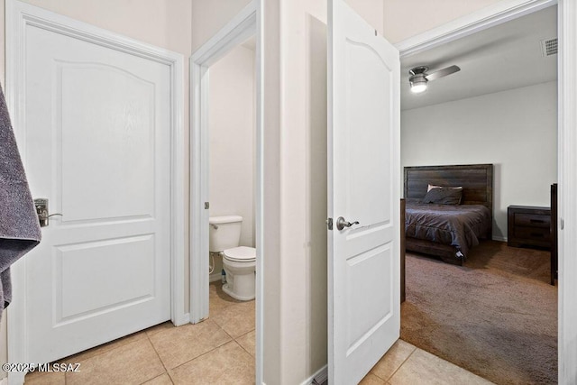 bathroom with tile patterned floors, toilet, and visible vents