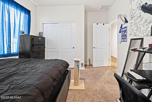 carpeted bedroom featuring visible vents, baseboards, and a closet