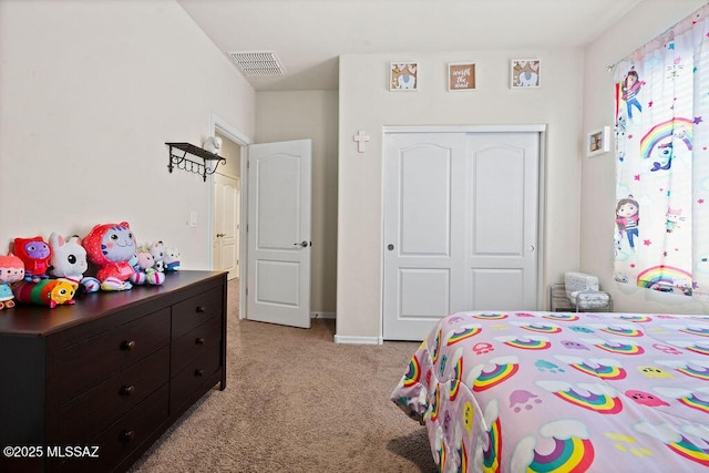 bedroom with baseboards, light colored carpet, visible vents, and a closet