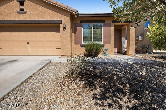 single story home with a garage, stucco siding, and driveway