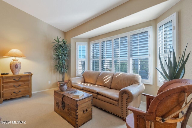 living room featuring light colored carpet and baseboards