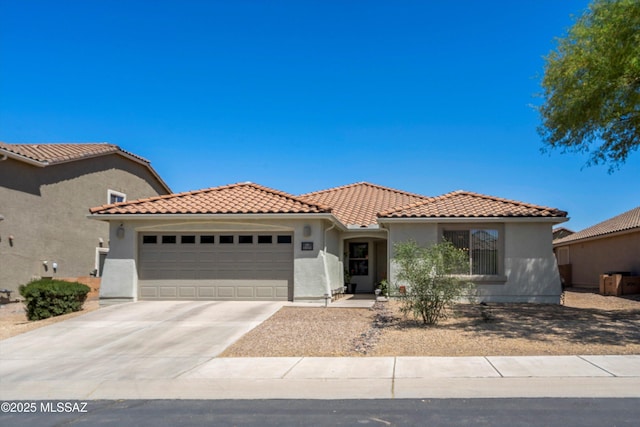 11042 W Case Way, Marana, AZ 85653 - mediterranean / spanish-style home with a garage, stucco siding, driveway, and a tiled roof