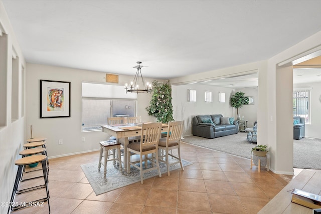 11042 W Case Way, Marana, AZ 85653 - dining space with light tile patterned flooring, a chandelier, and baseboards