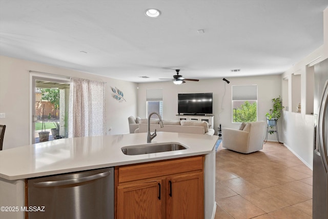 11042 W Case Way, Marana, AZ 85653 - kitchen with stainless steel dishwasher, open floor plan, a sink, ceiling fan, and light countertops