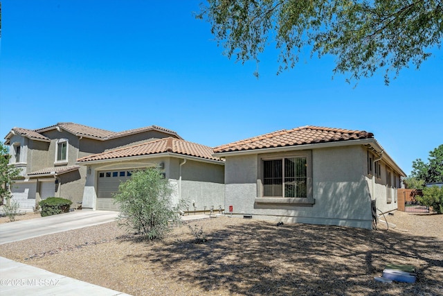 11042 W Case Way, Marana, AZ 85653 - mediterranean / spanish-style home featuring an attached garage, a tiled roof, stucco siding, and concrete driveway