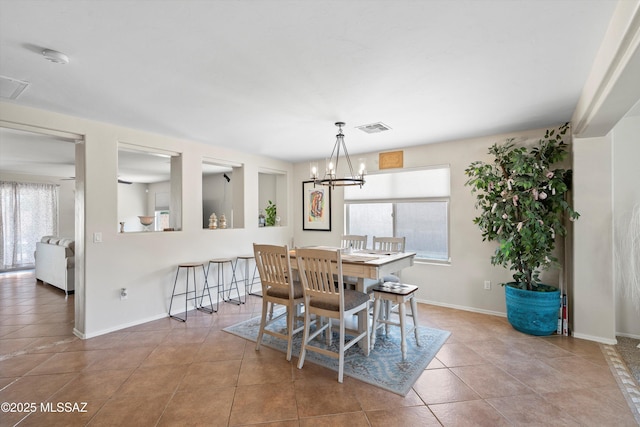 11042 W Case Way, Marana, AZ 85653 - dining room featuring healthy amount of natural light, tile patterned flooring, a chandelier, and baseboards