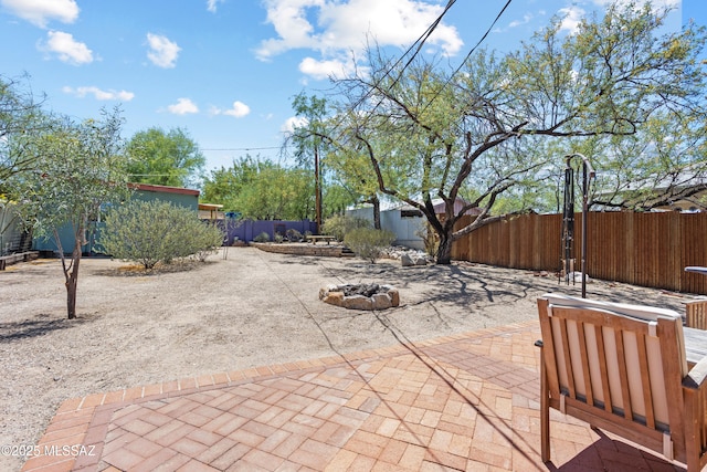 view of patio with fence private yard, a gate, and a fire pit