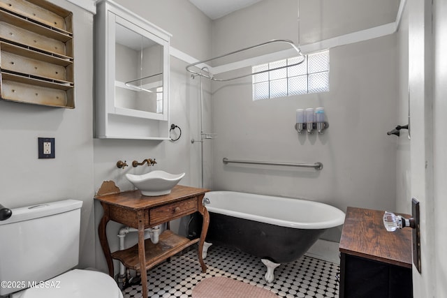 full bathroom featuring toilet, a sink, a tub to relax in, and a shower