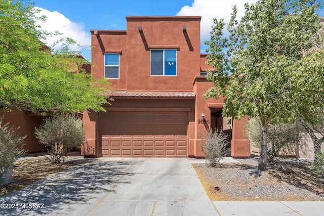 2868 N Silkie Pl, Tucson, AZ 85719 - pueblo revival-style home with an attached garage, driveway, and stucco siding