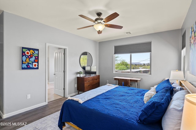 2868 N Silkie Pl, Tucson, AZ 85719 - bedroom with visible vents, baseboards, ceiling fan, and wood finished floors