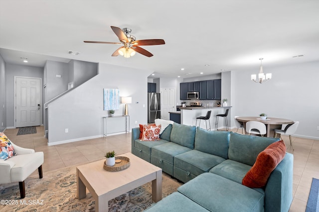 2868 N Silkie Pl, Tucson, AZ 85719 - living room featuring baseboards, visible vents, light tile patterned floors, and ceiling fan with notable chandelier