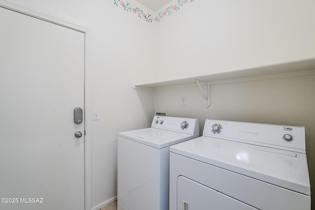 clothes washing area with laundry area and washer and clothes dryer