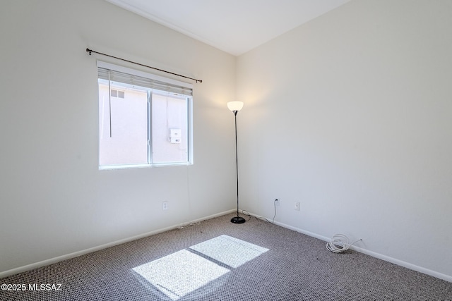 unfurnished room with baseboards and carpet flooring