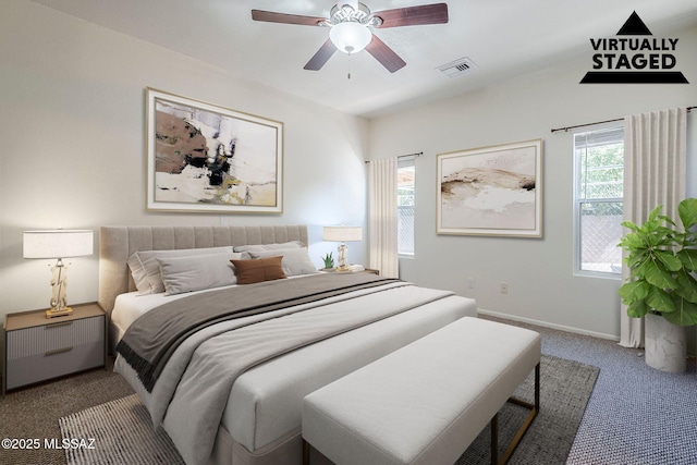 carpeted bedroom featuring visible vents, a ceiling fan, and baseboards