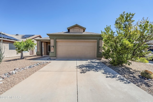 view of front of property with a garage, stucco siding, and concrete driveway