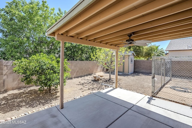 view of patio / terrace featuring an outdoor structure, a fenced backyard, and a shed
