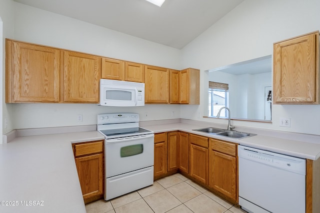 kitchen with white appliances, vaulted ceiling, a sink, and light countertops