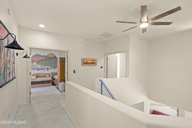 corridor with recessed lighting, baseboards, visible vents, and light tile patterned flooring