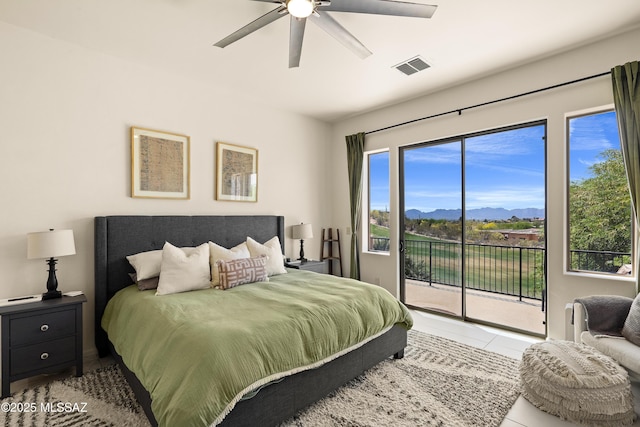 bedroom featuring visible vents, tile patterned flooring, access to exterior, a mountain view, and a ceiling fan