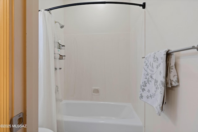 bathroom featuring shower / bath combo with shower curtain