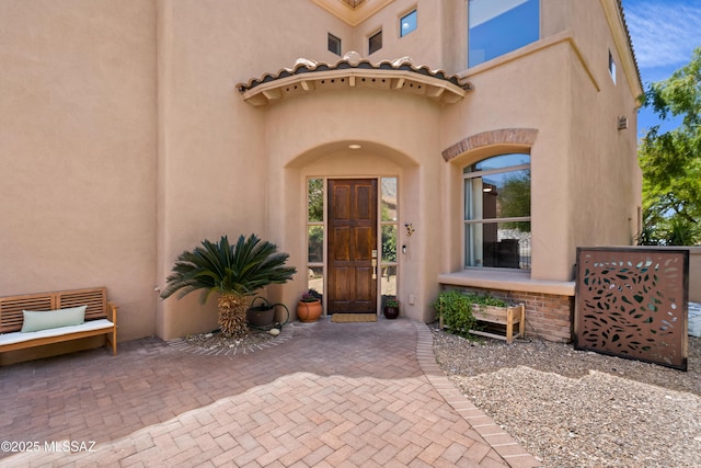 property entrance featuring stucco siding