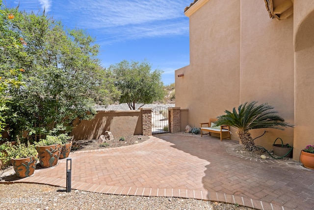 view of patio with fence and a gate