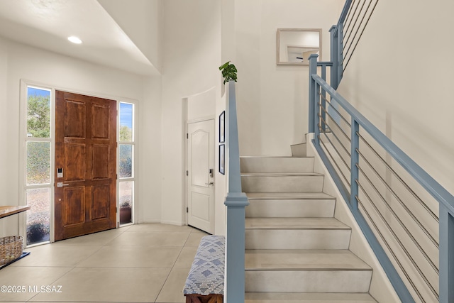 entryway featuring light tile patterned floors and stairway