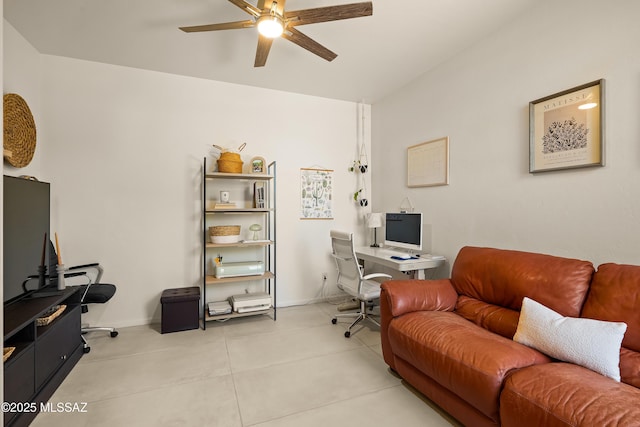office area with a ceiling fan, baseboards, and tile patterned flooring