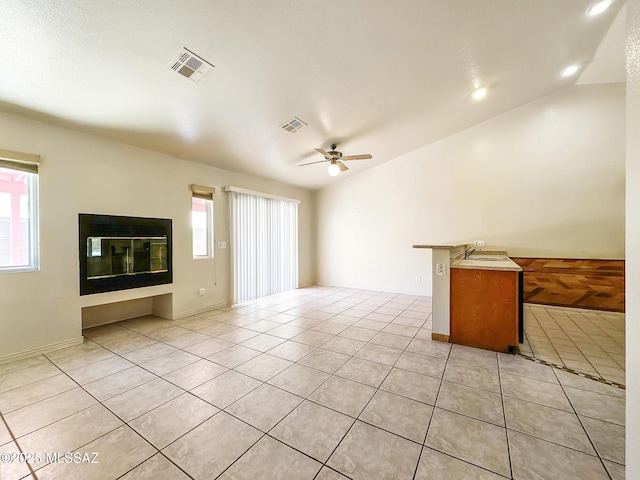 10084 E Bryonwood Ln, Tucson, AZ 85730 - unfurnished living room featuring a ceiling fan, light tile patterned floors, vaulted ceiling, and recessed lighting