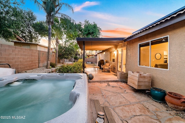 9696 E Paseo, San Rosendo, Tucson, AZ 85747 - pool at dusk with a fenced backyard, a hot tub, and a patio area