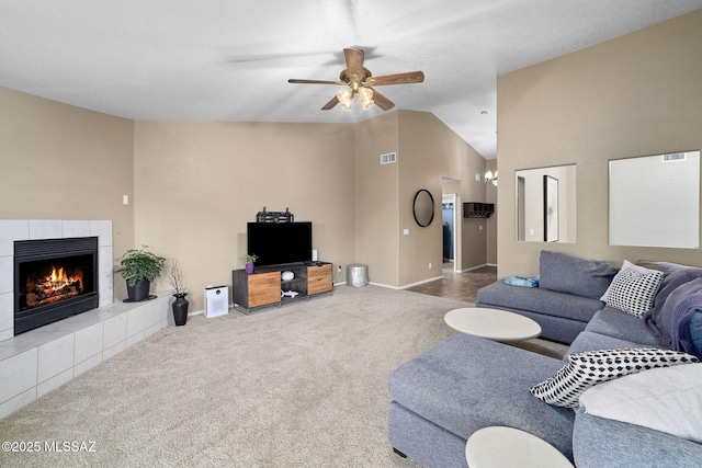 9696 E Paseo, San Rosendo, Tucson, AZ 85747 - living area featuring lofted ceiling, baseboards, ceiling fan, a tile fireplace, and carpet flooring