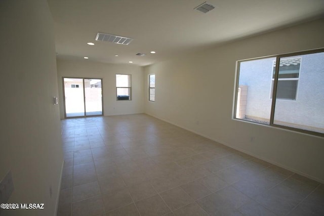 empty room with visible vents, recessed lighting, and baseboards