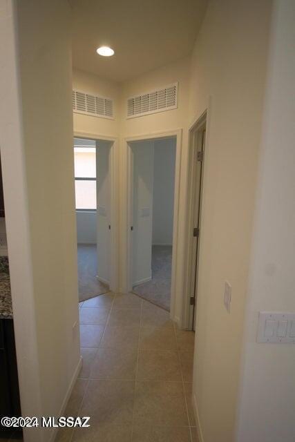 hallway with visible vents, recessed lighting, and light tile patterned flooring