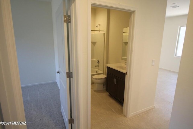 full bath with vanity, tile patterned floors, baseboards, toilet, and tub / shower combination