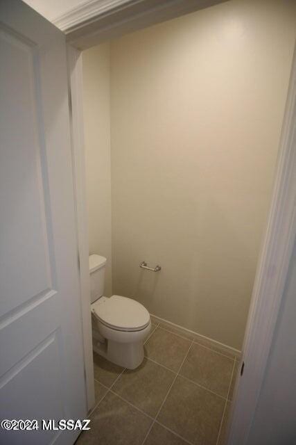 bathroom featuring toilet and tile patterned flooring