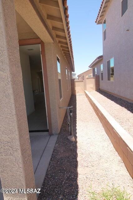 view of property exterior with fence and stucco siding