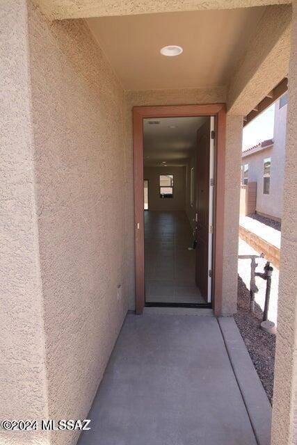 property entrance with stucco siding