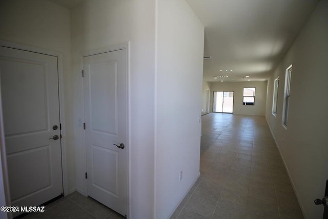 hallway with tile patterned floors