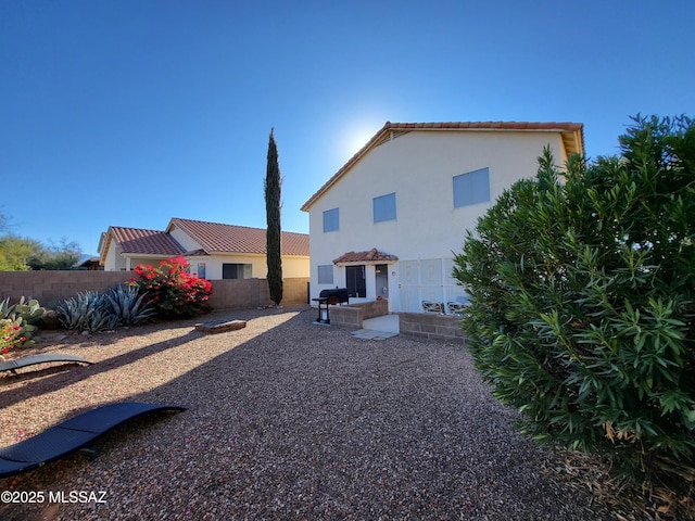 10161 E Queensgate Way, Tucson, AZ 85748 - rear view of house featuring fence, a tile roof, a patio area, and stucco siding