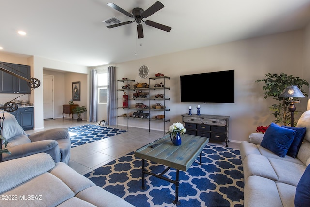 living area featuring a ceiling fan, baseboards, visible vents, and tile patterned floors