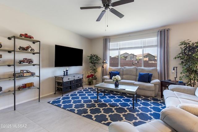 living room featuring baseboards, ceiling fan, and light tile patterned flooring