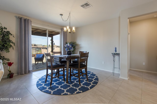 dining room with visible vents, baseboards, light tile patterned flooring, and a notable chandelier