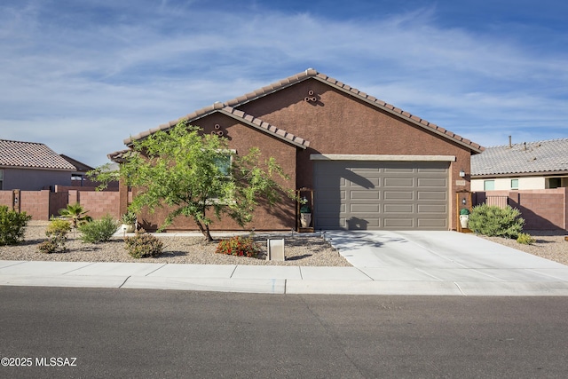 single story home with fence, an attached garage, a tile roof, stucco siding, and driveway