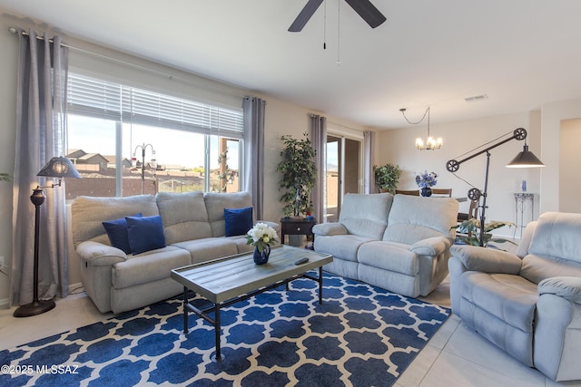 tiled living room with visible vents and ceiling fan with notable chandelier