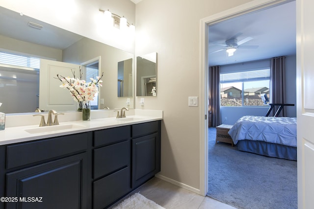 full bath featuring connected bathroom, a ceiling fan, a sink, and double vanity
