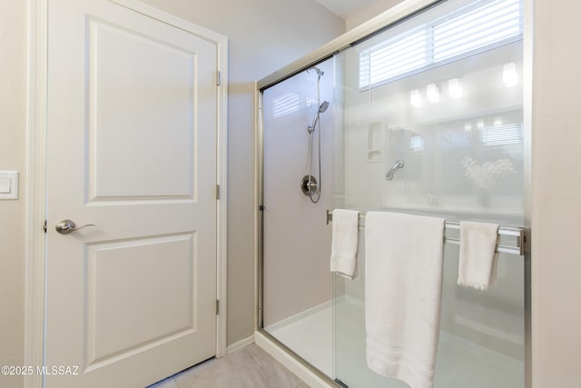 full bathroom with tile patterned flooring and a stall shower