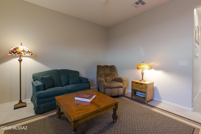 living room with baseboards and visible vents