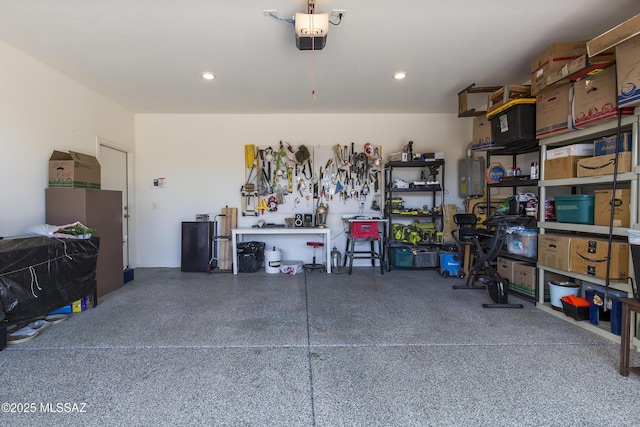 garage with a workshop area and a garage door opener